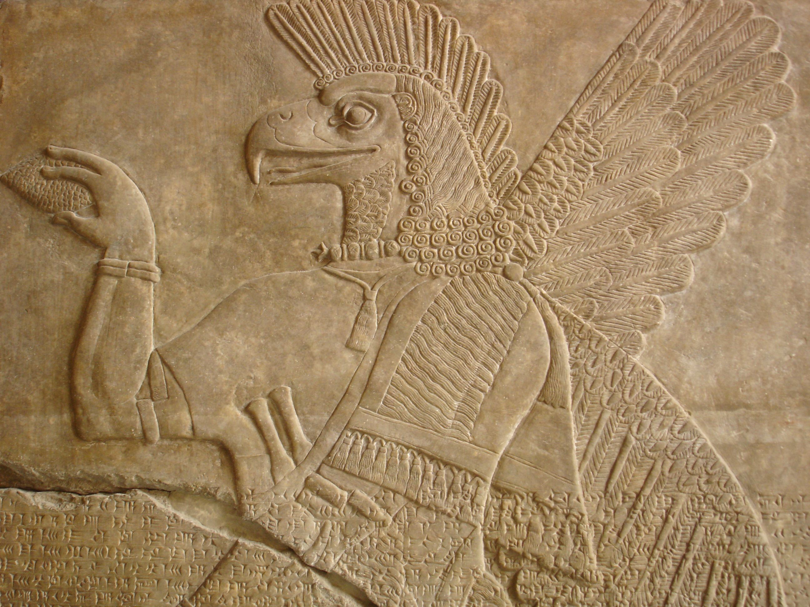 Ancient Mesopotamian stone relief depicting a mythological winged figure